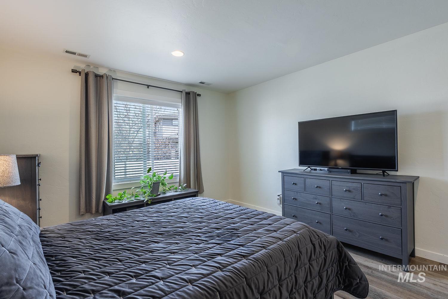 1332 West Raelin Drive Nampa, ID 83686 - Photo 24 of 48 Bedroom with wood finished floors and baseboards