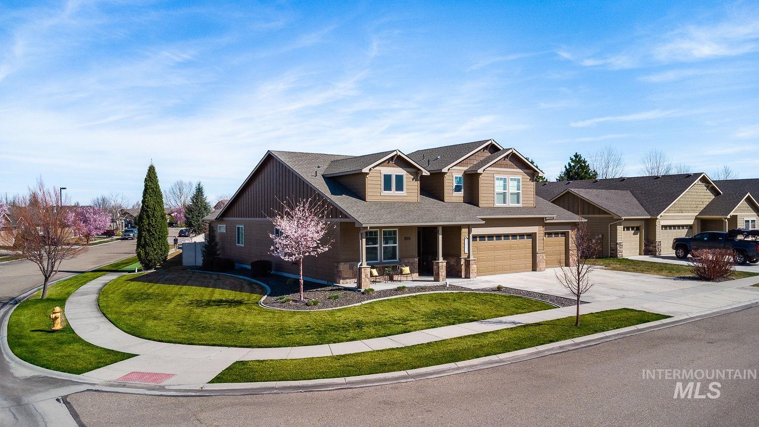 1332 West Raelin Drive Nampa, ID 83686 - Photo 3 of 48 Craftsman inspired home with covered porch, driveway, an attached garage, roof with shingles, and a front lawn