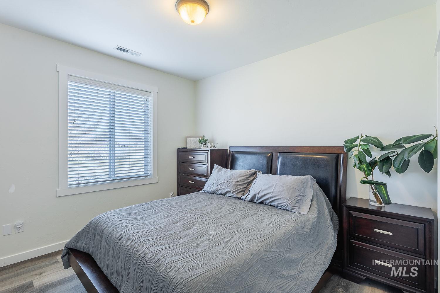 1332 West Raelin Drive Nampa, ID 83686 - Photo 32 of 48 Bedroom with wood finished floors and baseboards