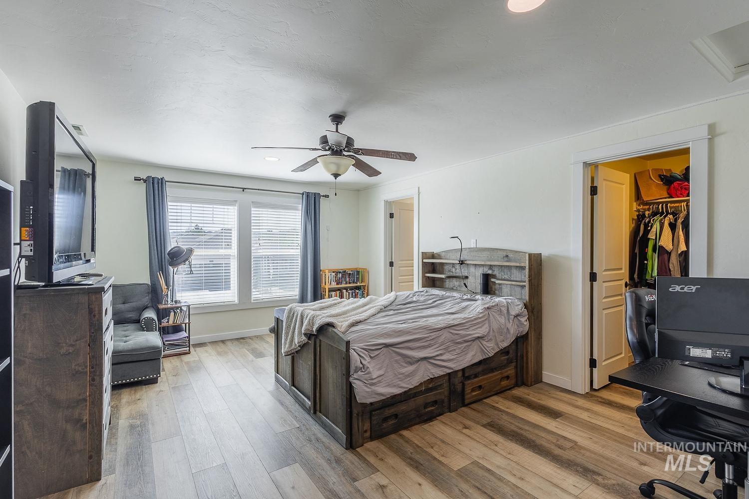 1332 West Raelin Drive Nampa, ID 83686 - Photo 39 of 48 Bedroom with light wood-type flooring, a spacious closet, ceiling fan, and recessed lighting
