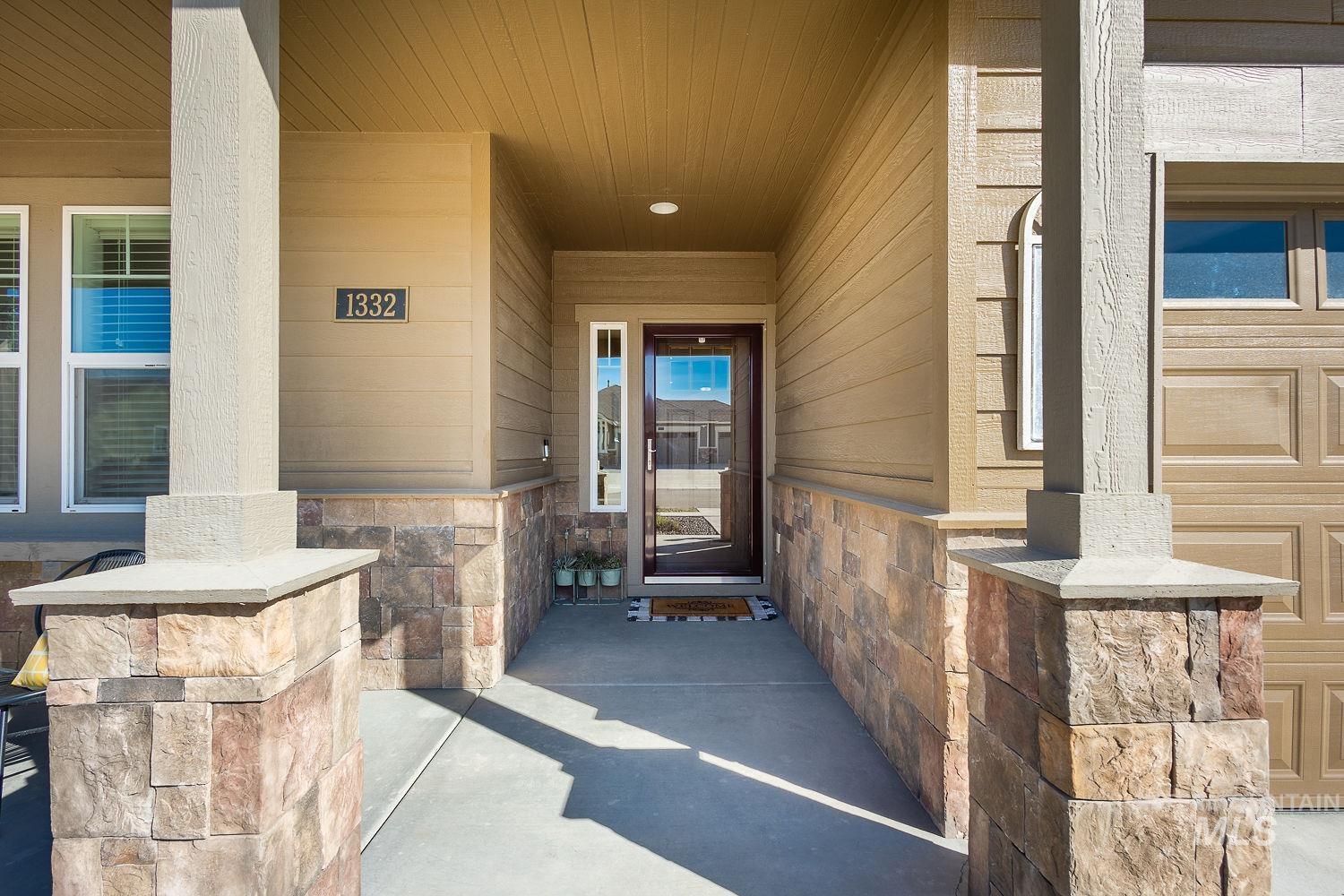 1332 West Raelin Drive Nampa, ID 83686 - Photo 4 of 48 View of exterior entry featuring a porch and stone siding