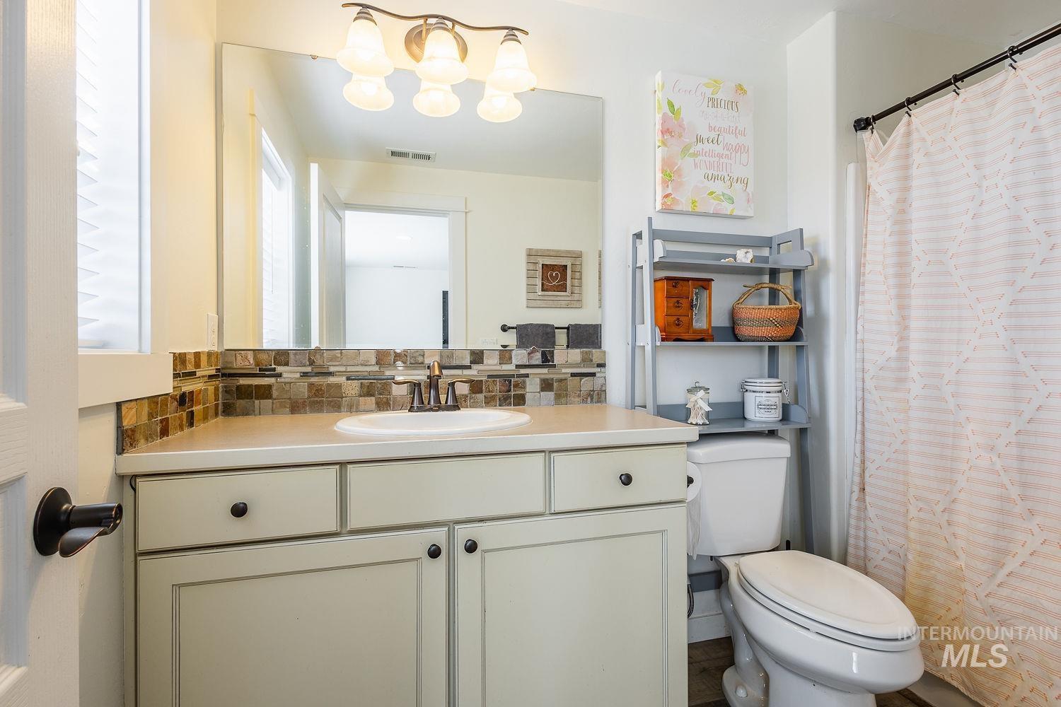 1332 West Raelin Drive Nampa, ID 83686 - Photo 41 of 48 Full bath featuring tasteful backsplash, vanity, and a shower with curtain