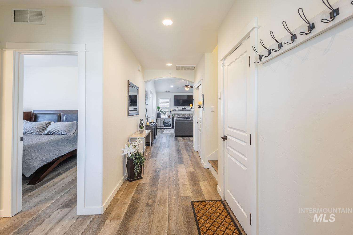 1332 West Raelin Drive Nampa, ID 83686 - Photo 5 of 48 Hallway featuring recessed lighting, light wood finished floors, and arched walkways