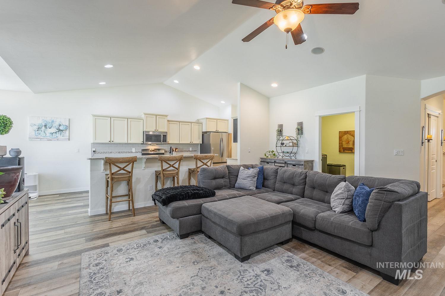 1332 West Raelin Drive Nampa, ID 83686 - Photo 10 of 48 Living room with ceiling fan, light wood-style floors, lofted ceiling, and recessed lighting