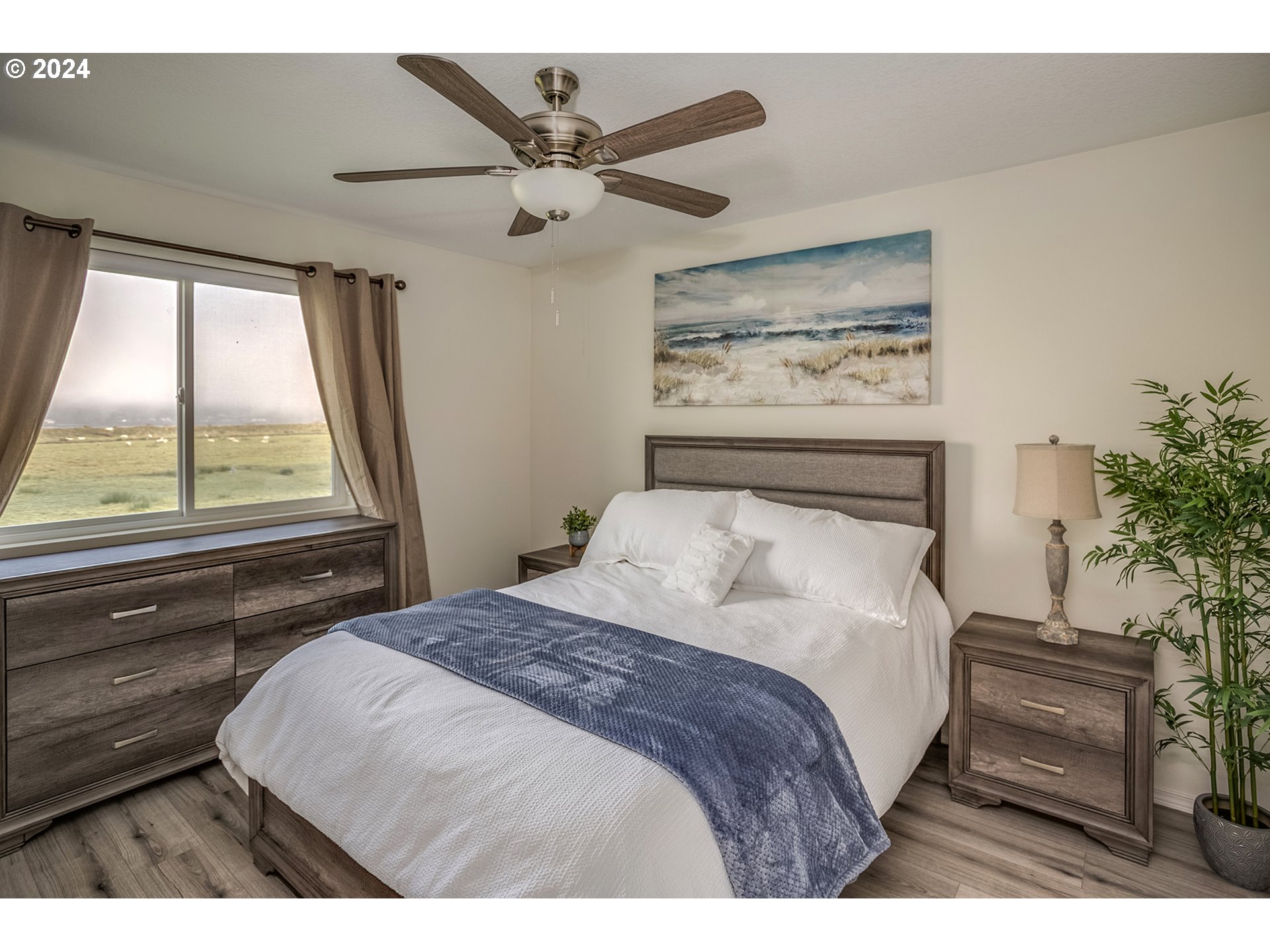 92597 Wireless Road Astoria, OR 97103 - Photo 17 of 35 a bedroom with a large bed and a large window