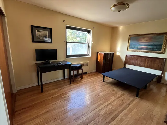 a living room with furniture wooden floor and a window