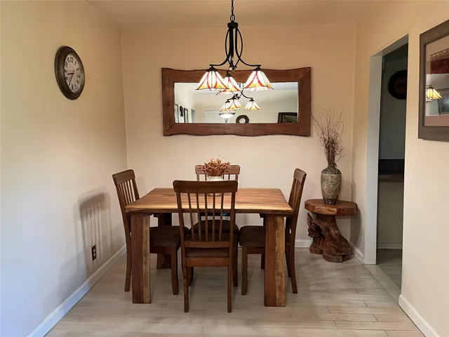 a view of a dining room filled with furniture and window