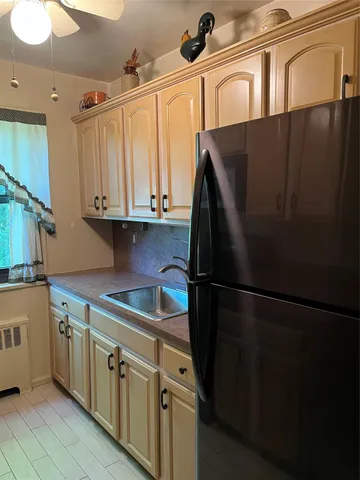 a kitchen with stainless steel appliances a refrigerator sink and cabinets