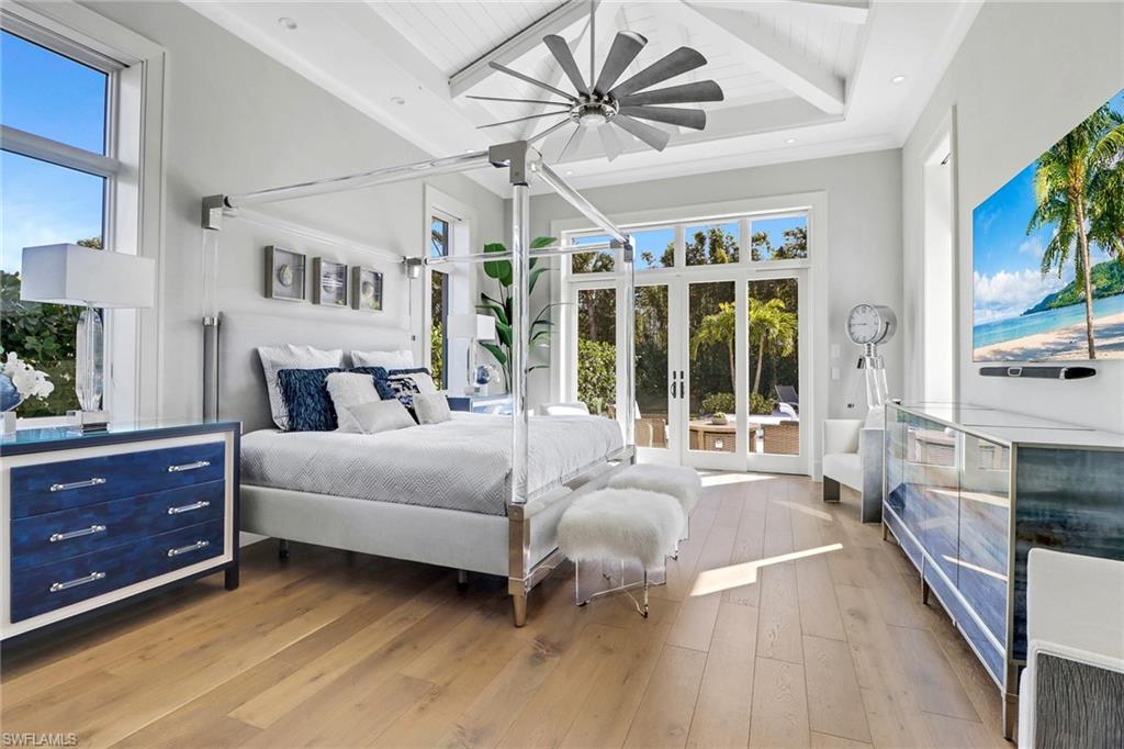 636 Portside Drive Naples, FL 34103 - Photo 11 of 50 a spacious bedroom with a bed and a large window