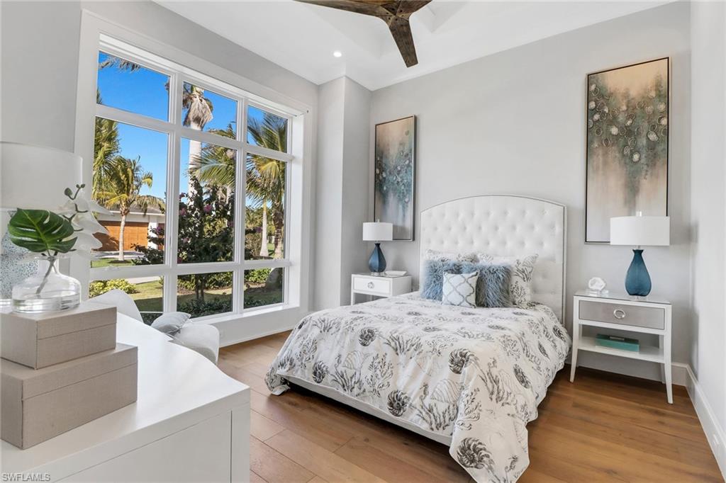 636 Portside Drive Naples, FL 34103 - Photo 26 of 50 a bedroom with a large bed and a large window