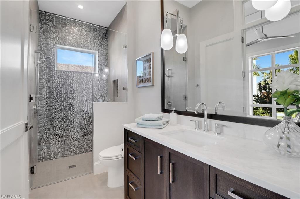 636 Portside Drive Naples, FL 34103 - Photo 27 of 50 a bathroom with a sink and a mirror