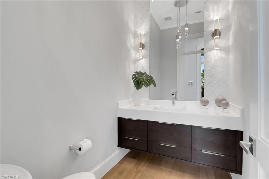 636 Portside Drive Naples, FL 34103 - Photo 32 of 50 a bathroom with a sink and a mirror