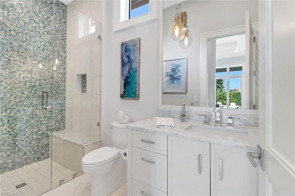 636 Portside Drive Naples, FL 34103 - Photo 34 of 50 a bathroom with a sink a toilet and shower