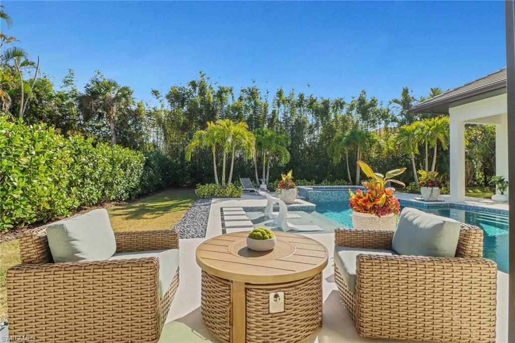 636 Portside Drive Naples, FL 34103 - Photo 42 of 50 a view of a patio with couches table and chairs and potted plants
