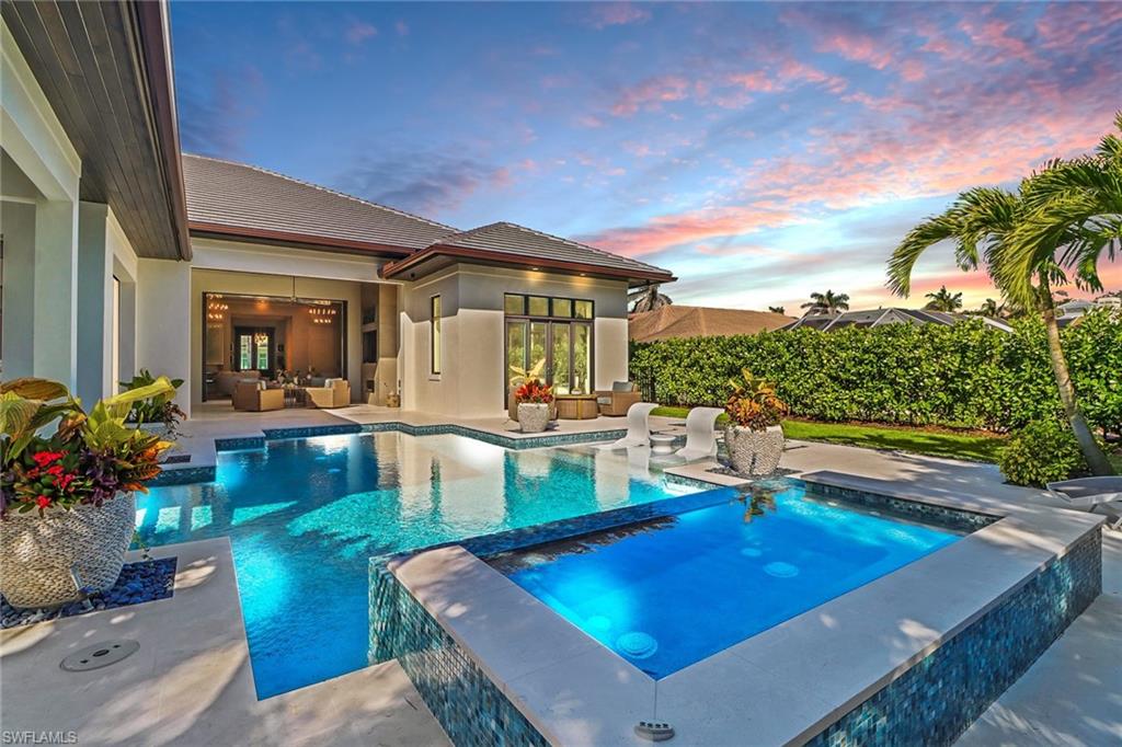 636 Portside Drive Naples, FL 34103 - Photo 43 of 50 a view of a swimming pool with outdoor seating
