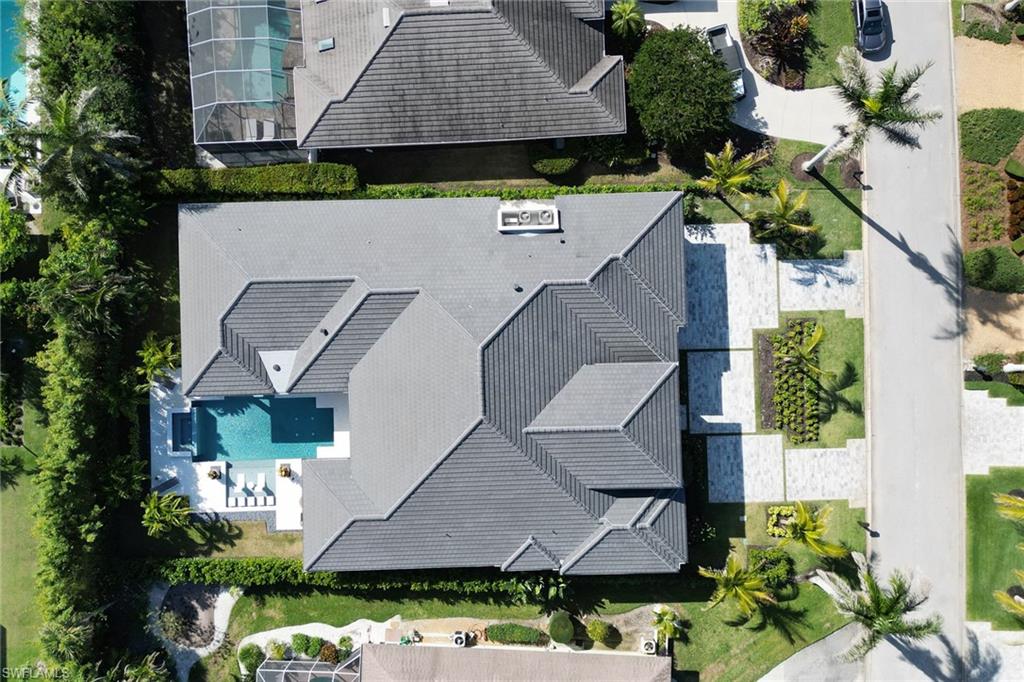 636 Portside Drive Naples, FL 34103 - Photo 45 of 50 an aerial view of a house with a yard wooden table and chairs