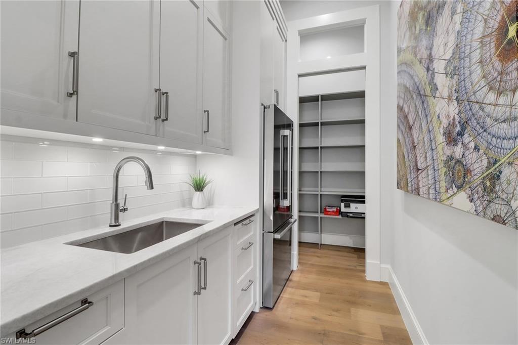 636 Portside Drive Naples, FL 34103 - Photo 8 of 50 a kitchen with a sink and cabinets