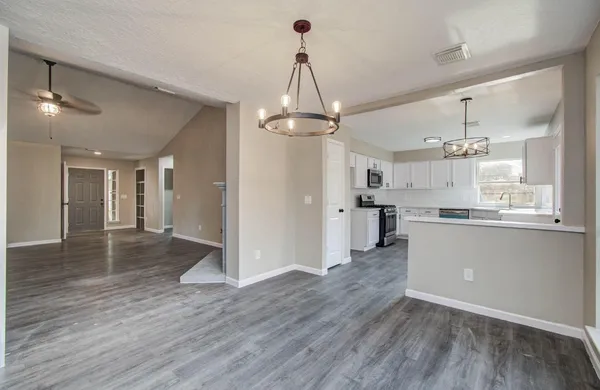 a view of a kitchen with wooden floor and a kitchen
