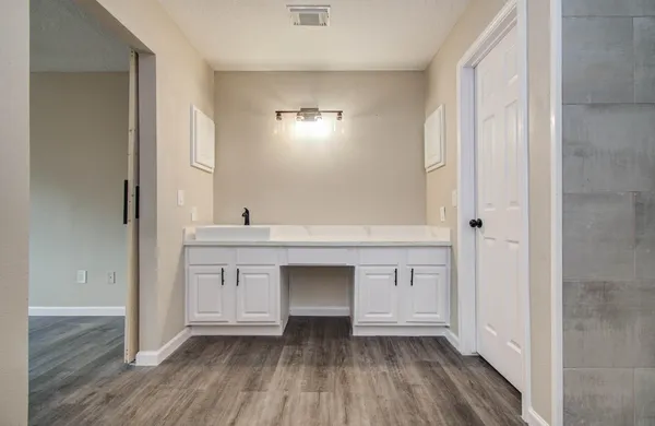 a view of cabinets with wooden floor and window
