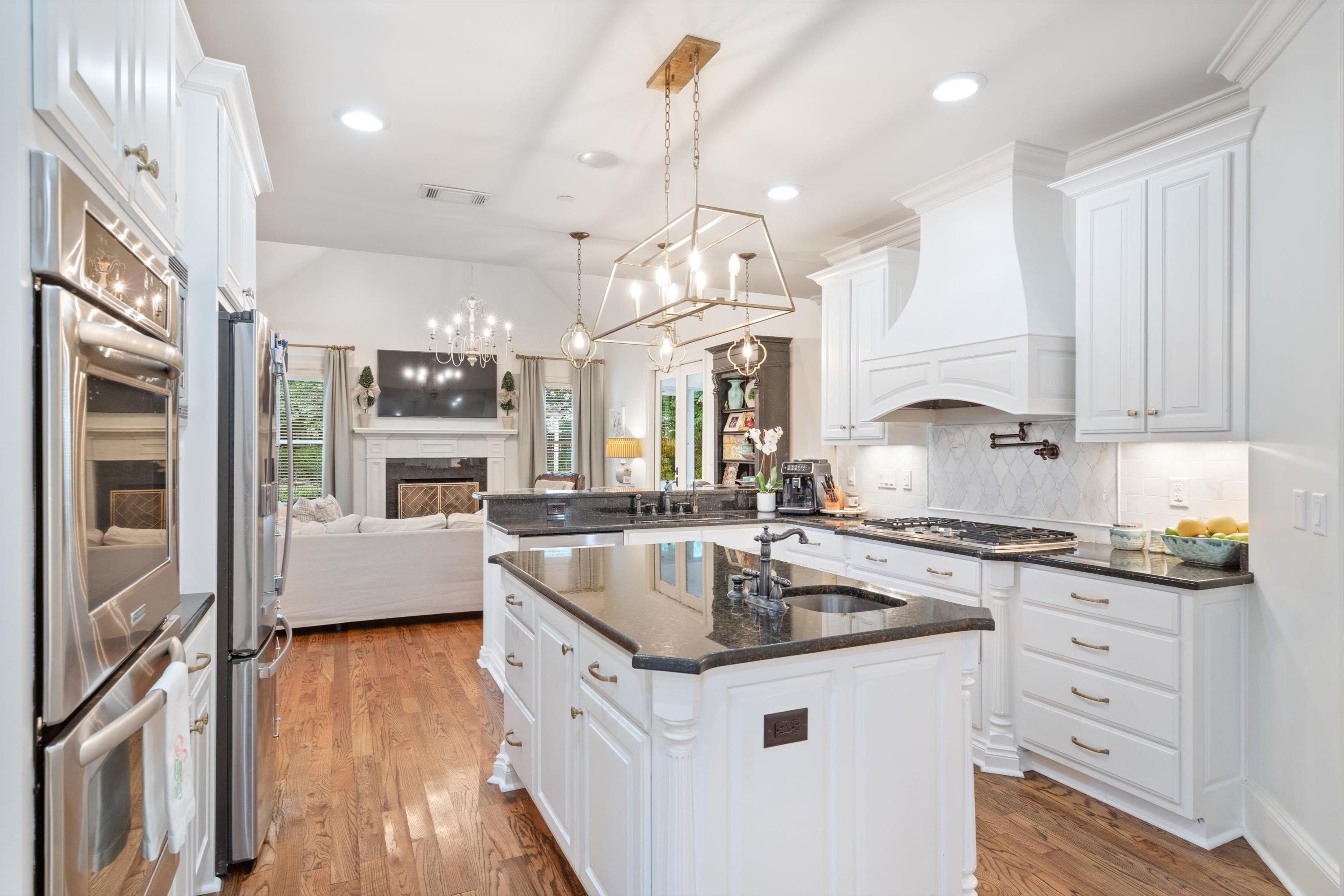4621 Spring Meadow Way North Olive Branch, MS 38654 - Photo 11 of 40 a kitchen with stainless steel appliances granite countertop a sink a stove and a wooden floors