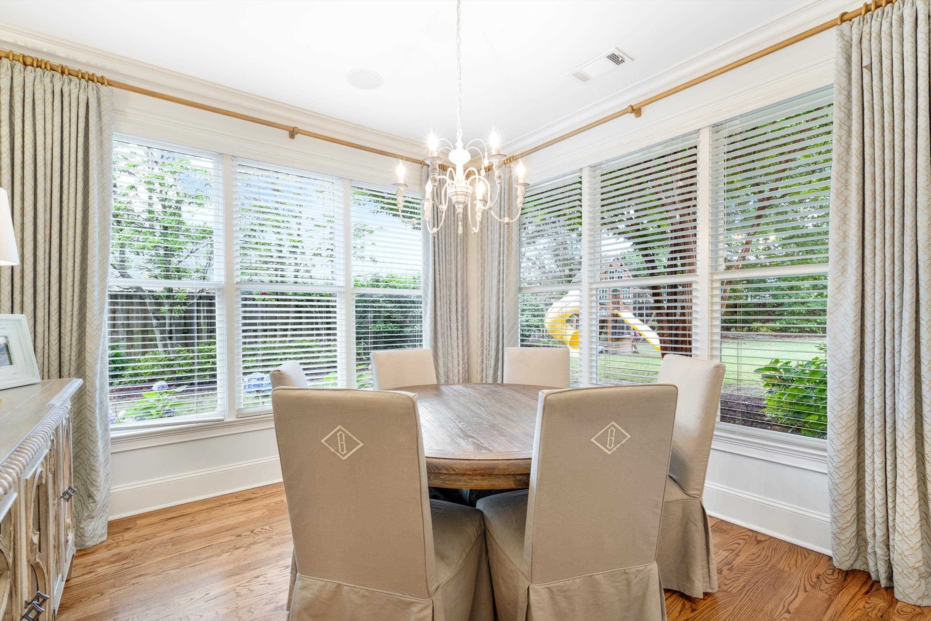 4621 Spring Meadow Way North Olive Branch, MS 38654 - Photo 15 of 40 a view of a dining room with furniture large windows and wooden floor