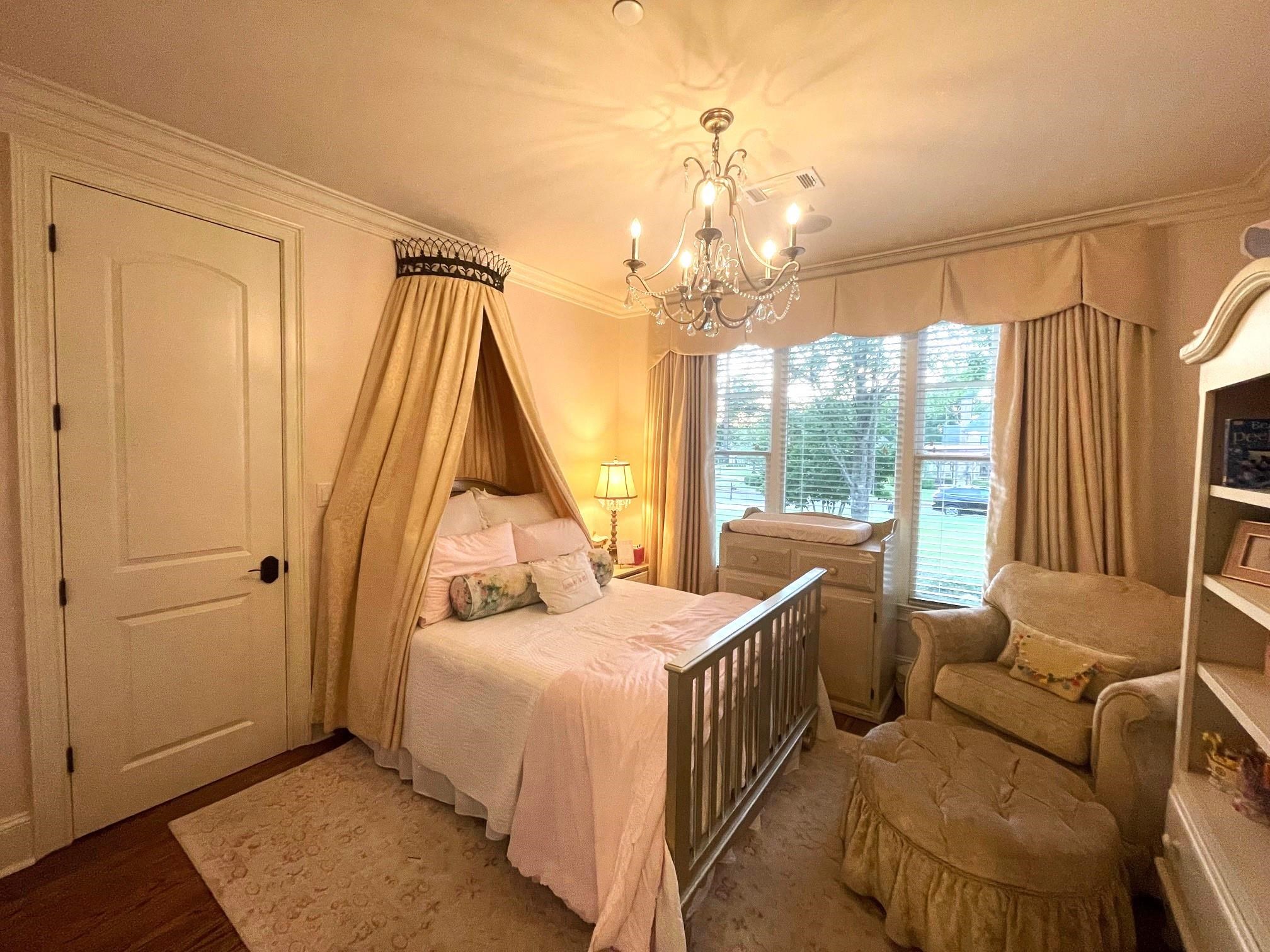 4621 Spring Meadow Way North Olive Branch, MS 38654 - Photo 22 of 40 a bed room with a bed and a chandelier