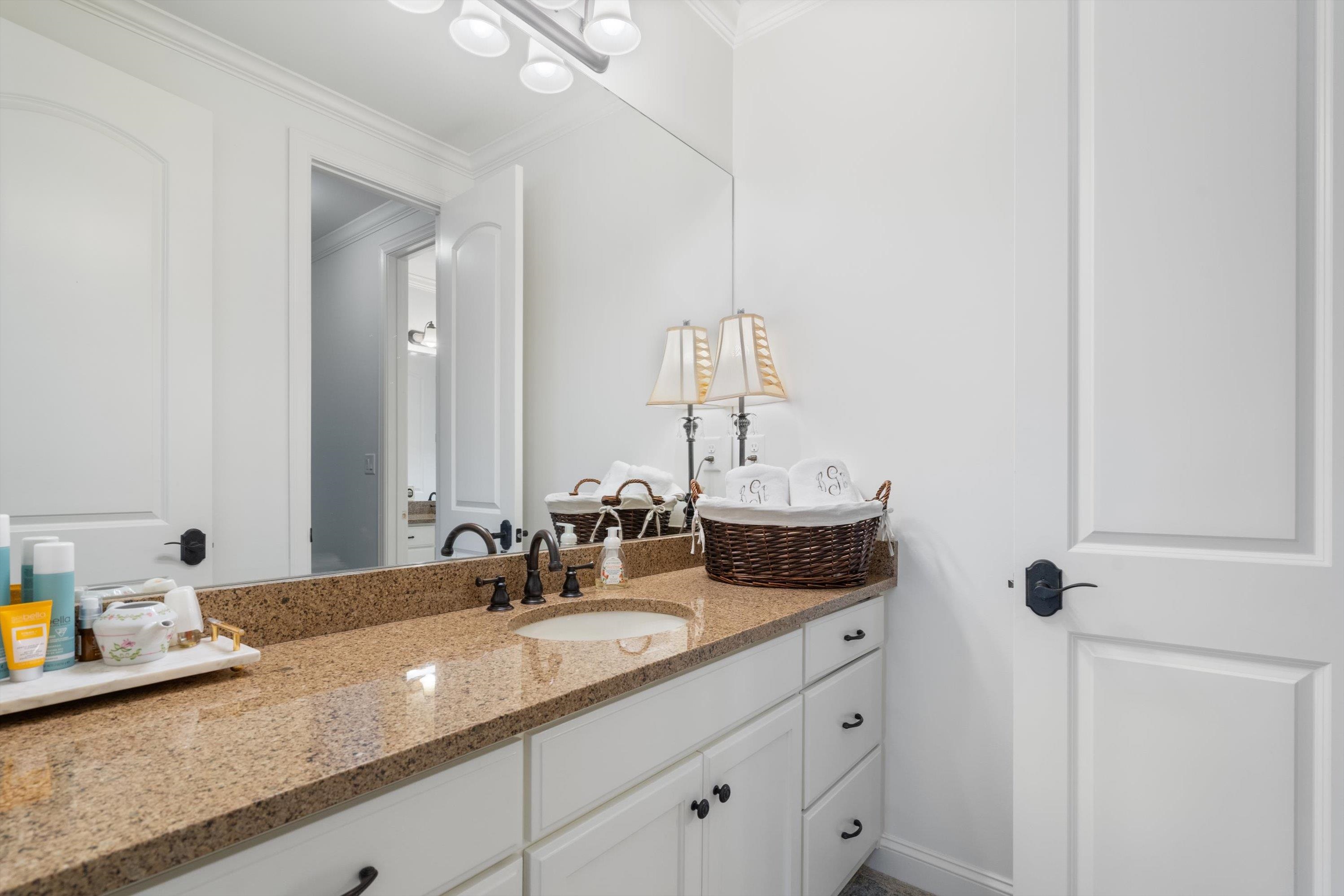 4621 Spring Meadow Way North Olive Branch, MS 38654 - Photo 26 of 40 a bathroom with a granite countertop sink and a mirror
