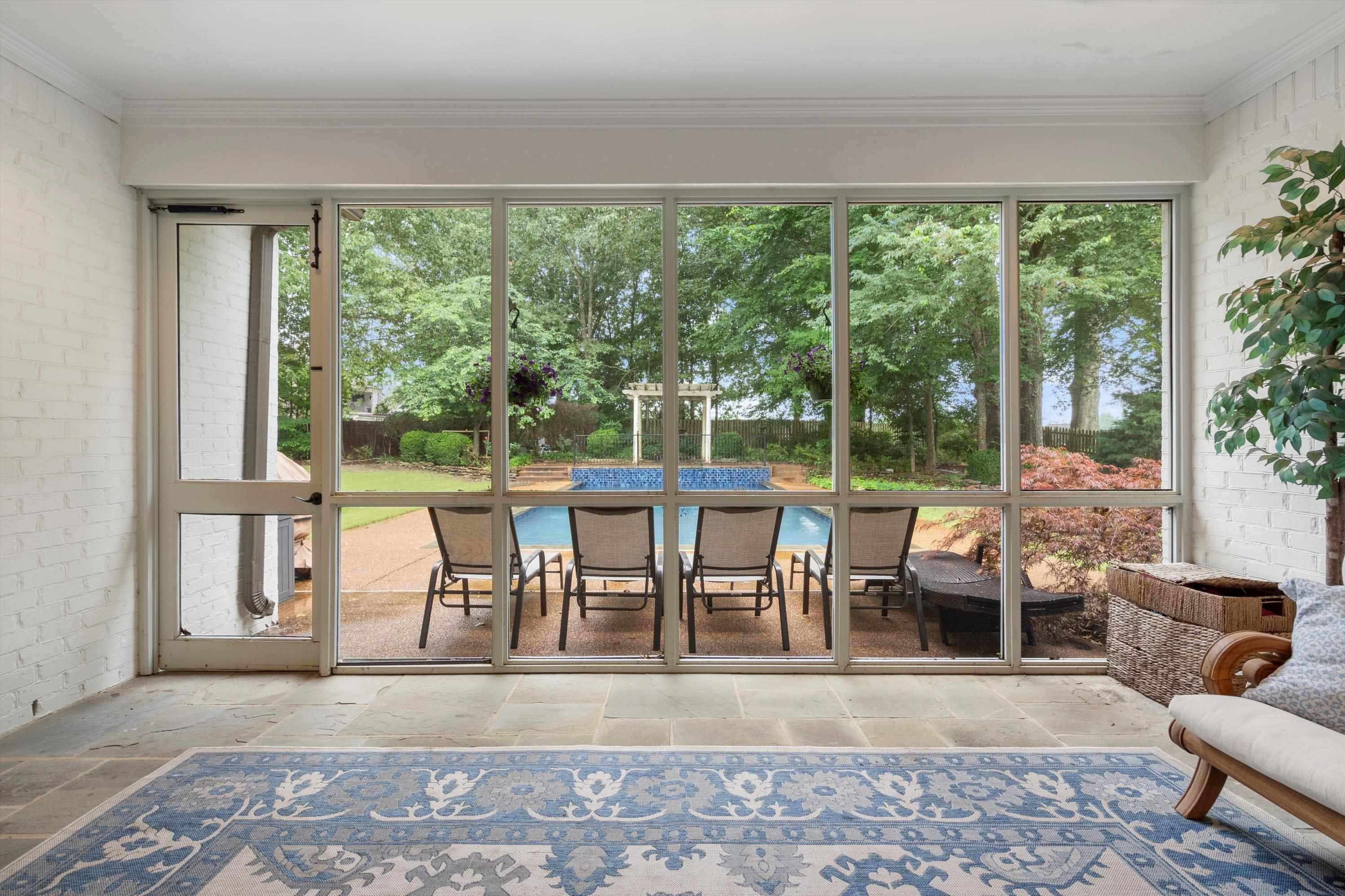 4621 Spring Meadow Way North Olive Branch, MS 38654 - Photo 32 of 40 a view of a dining room with furniture large windows and wooden floor