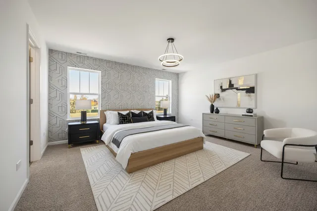 a spacious bedroom with a bed couch and window