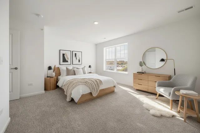 a bed room with a bed mirror and a window