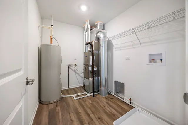 a view of a refrigerator in kitchen and an empty room
