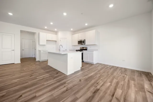 a kitchen with stainless steel appliances a sink and a refrigerator