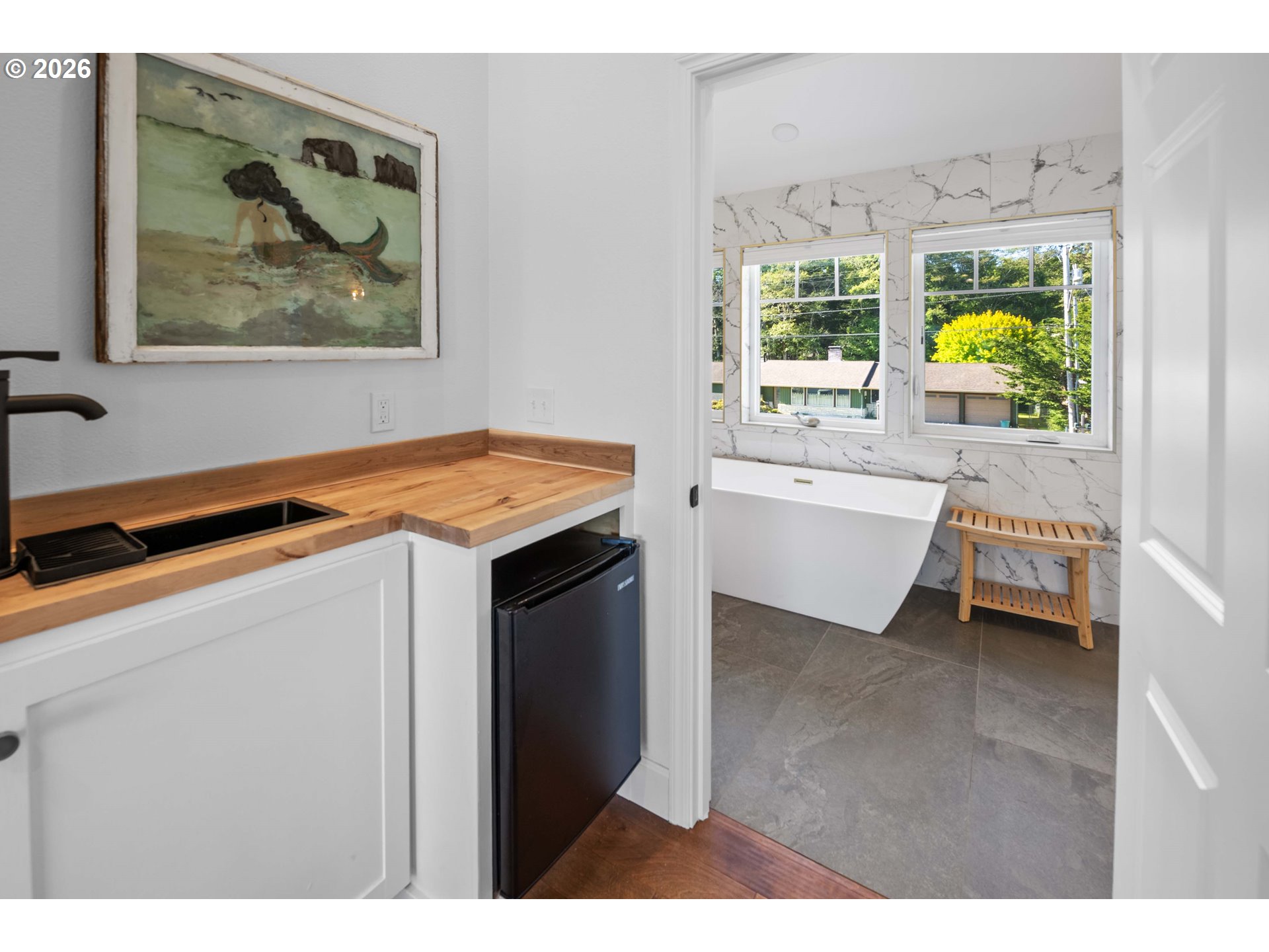 3232 Sunset Boulevard Seaside, OR 97138 - Photo 23 of 48 a dining room with a bed and a painting on the wall