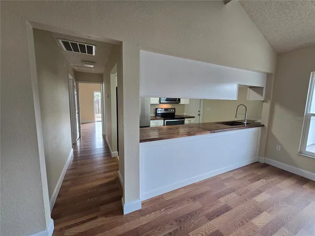 a kitchen with granite countertop a refrigerator and a sink