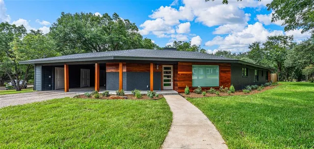 a front view of house with yard and green space
