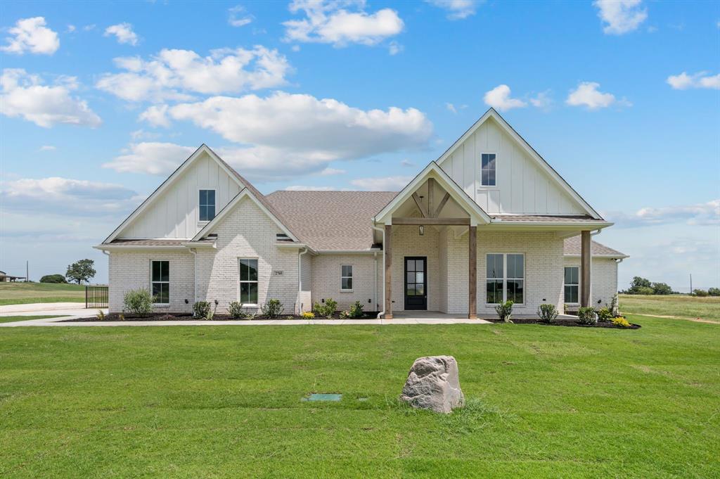 2705 Gospel Road Tolar, TX 76476 - Photo 1 of 36 Brick exterior with brick, board and batten gables, covered porch with wood columns and beam accents, dark-framed entry door, and a concrete driveway