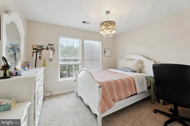 a bedroom with a bed and a table in it