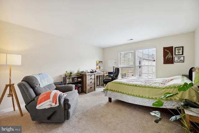 a bedroom with bed and window