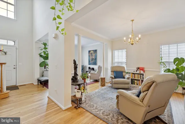 a living room with furniture and a chandelier