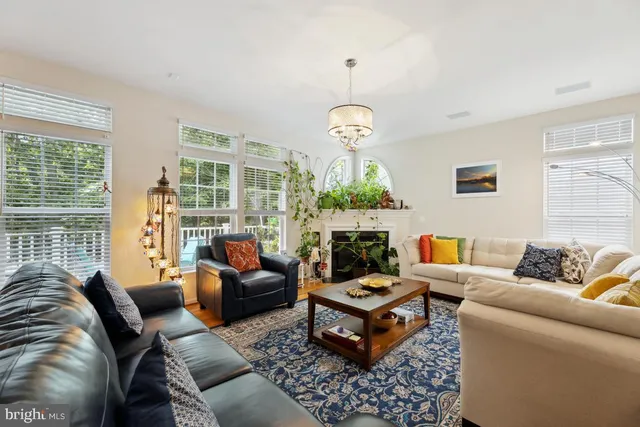 a living room with furniture a table and a large window