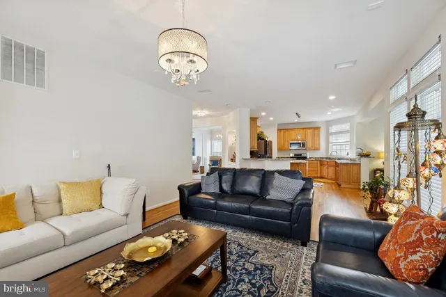 a living room with furniture a rug and a chandelier