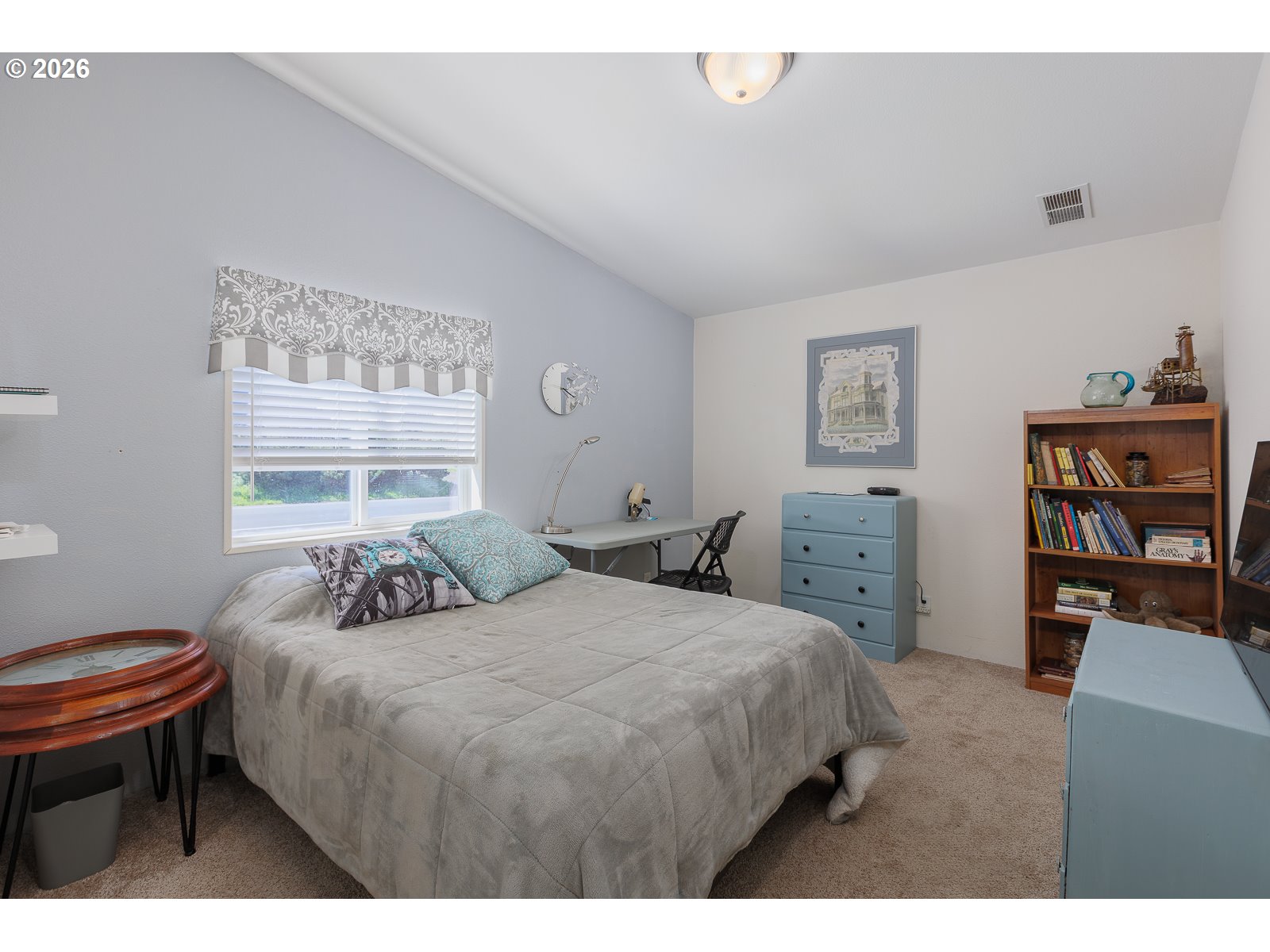 2018 Northwest Oceanic Loop Waldport, OR 97394 - Photo 22 of 35 a bedroom with a bed a dresser and book shelf