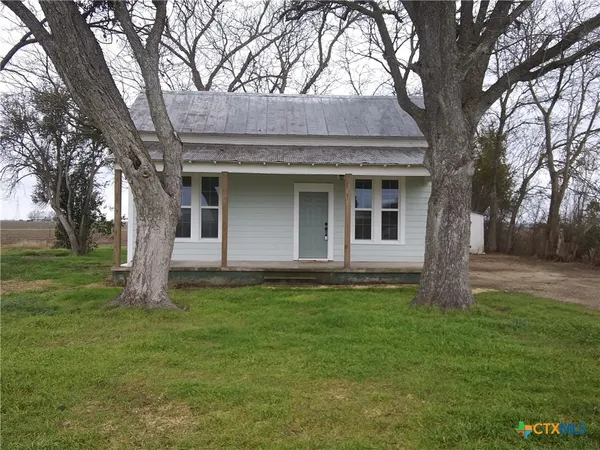 a house that has tree in front of a house
