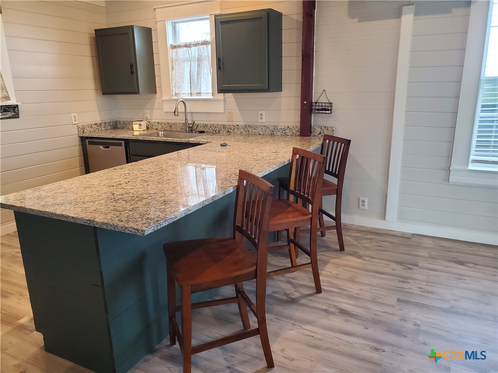 7830 Barbarosa Road New Braunfels, TX 78130 - Photo 5 of 14 a kitchen with a wooden floor and chairs