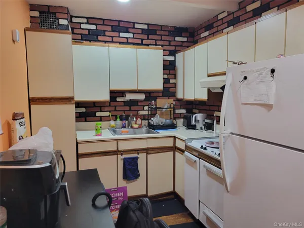 a kitchen with stainless steel appliances a stove a sink and a refrigerator