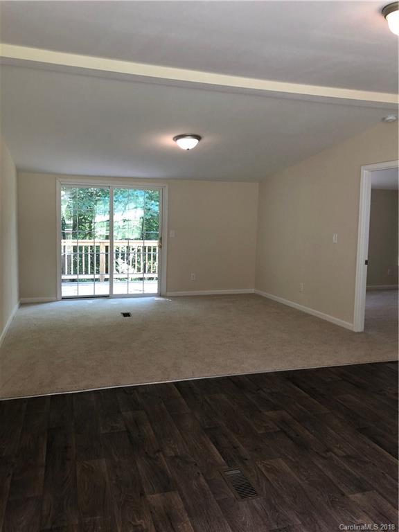 1785 Doe Court Iron Station, NC 28080 - Photo 3 of 14 an empty room with wooden floor and windows
