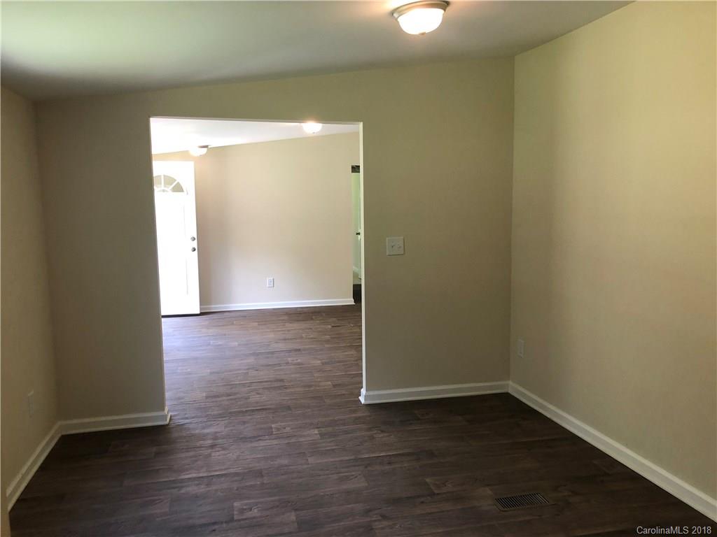 1785 Doe Court Iron Station, NC 28080 - Photo 6 of 14 an empty room with wooden floor and windows