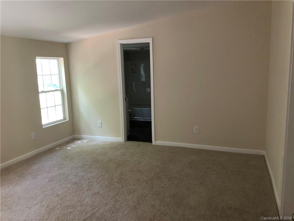 1785 Doe Court Iron Station, NC 28080 - Photo 9 of 14 an empty room with windows and closet