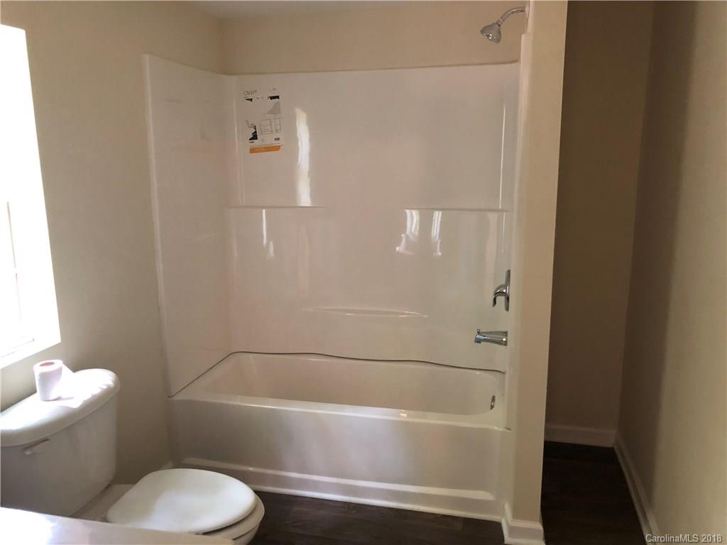 1785 Doe Court Iron Station, NC 28080 - Photo 10 of 14 a bathroom with a toilet and a bath tub