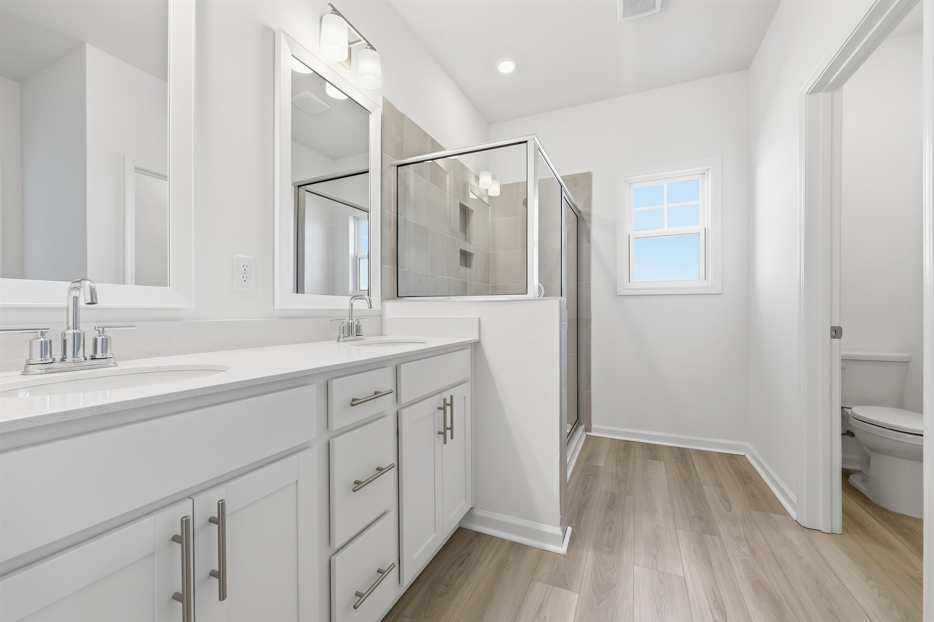 150 River Birch Drive Loris, SC 29569 - Photo 12 of 39 Full bath featuring double vanity, a shower stall, and light wood-type flooring